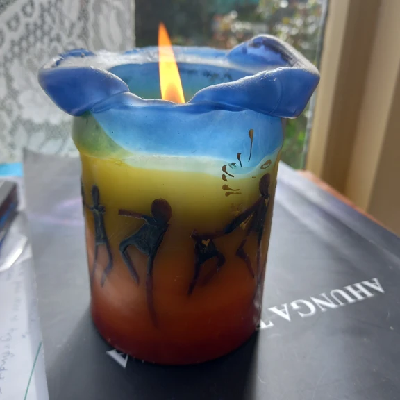 A decorative candle, lit