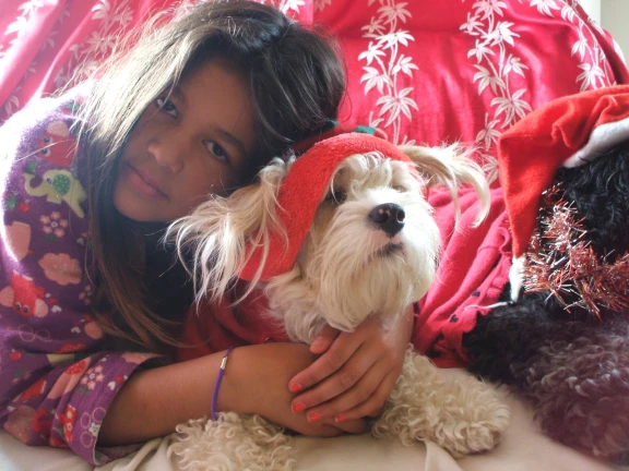 Girl cuddling her dog